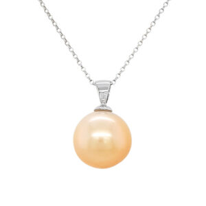 A round golden pearl hangs from a silver chain