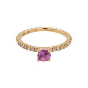 A gold ring with a pink sapphire