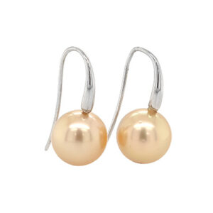 Golden pearls dangle from silver hooks